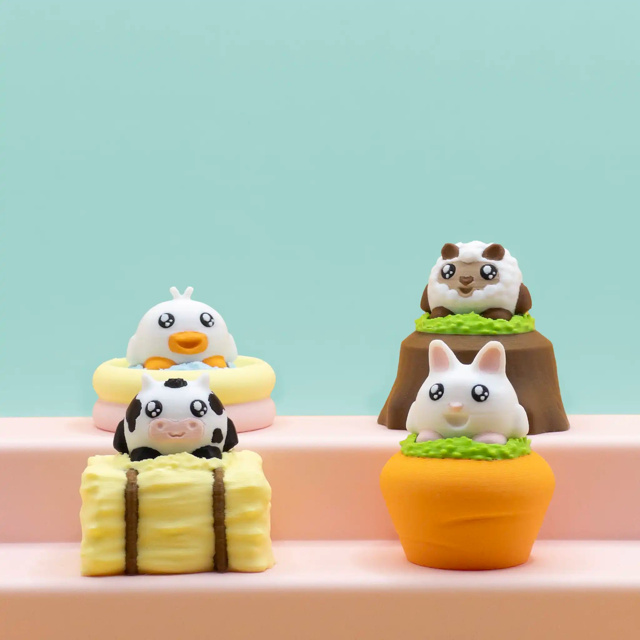 A full set of four adorable animal charms from the Farm Friends series: a cow on a hay bale, a duck in an inflatable pool, a sheep on a tree stump, and a bunny in a carrot pot—displayed together on pastel steps with a mint green background.